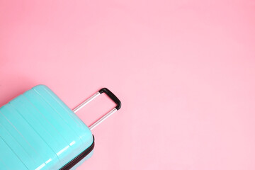 Sticker - One new turquoise suitcase on pink background, above view. Space for text