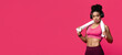 © Prostock-studio - Confident well fit afro girl with headset and towel on having break during training, red background, panorama with copy space