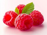 A group of raspberries with leaves on a white surface