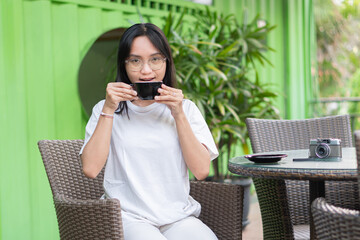 Young Woman Enjoying Coffee at a Cafe