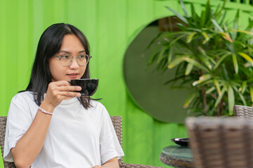 Young Woman Enjoying Coffee at a Cafe