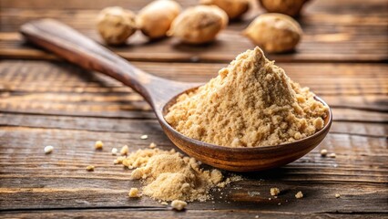 A spoonful of maca powder with fresh roots on rustic table