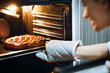 © Prostock-studio - Homemade baking. Happy housewife taking fresh pie out of oven at home
