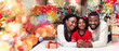 © Prostock-studio - Portrait of loving african american family of three lying on floor near Christmas tree on white blanket, bonding together, and smiling at camera
