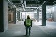 © momostudio - Construction Worker Standing in a Large Empty Room