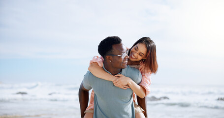 Canvas Print - Love, piggyback and happy with interracial couple at beach for travel destination, summer and honeymoon vacation. Relax, tropical and adventure with man and woman for holiday, bonding or romance