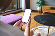 © Farknot Architect - Mockup image of a woman holding mobile phone with blank desktop white screen at home