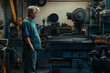 © WETDREAM - A man stands in front of a machine in a workshop