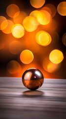 Wall Mural -  A shiny ball sits atop a wooden table, with a blurred backdrop of lights