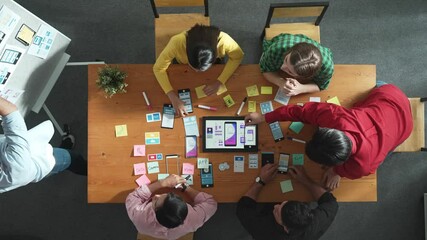 Top view of software developer writing idea about Ux ui design for mobile phone interface. Programmer brainstorm and planning wireframe prototype by looking tablet display smart software. Convocation.