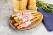 © Andrei Starostin - Crispy grissini italian bread with bacon