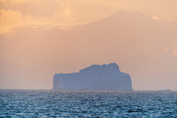 Impression of a giant icebeg illuminated by a beautiful sunset over the Bransfield strait in Antarctica