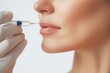 © Panuma - Close-up of a woman receiving a lip injection, showcasing beauty and cosmetic enhancement treatments.