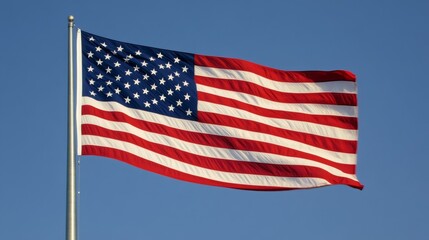 A vibrant American flag waving against a clear blue sky symbolizing freedom and patriotism.