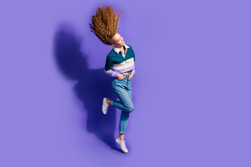 Wall Mural - Full size photo of nice young girl flying hair empty space ad isolated on violet color background