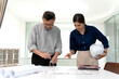 © sabthai - Architect and engineer are discussing and viewing and editing plans