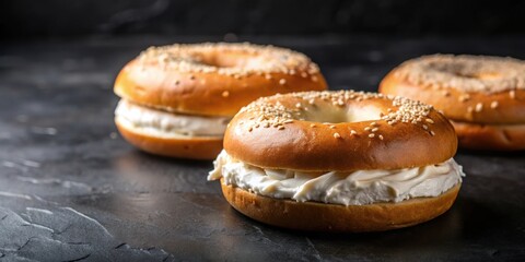 Wall Mural - Bagels with cream cheese on a black background