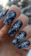 Closeup of Hands with Dark Blue Nail Polish and Silver Snowflake Designs