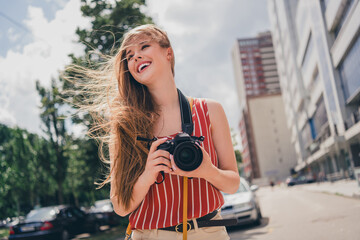 Wall Mural - Photo of positive cute girl wear trendy clothes walk city center take picture summer weather outdoors