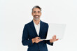 © insta_photos - Happy mature business man using laptop standing isolated on white background. Middle aged professional businessman ceo executive wearing suit holding computer working looking at camera, portrait.