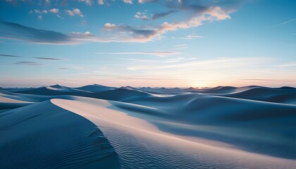 Wall Mural - Endless smooth sand dunes under a clear blue sky, embodying the tranquility and beauty of a minimalist desert landscape