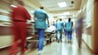 © Media Srock - Blurred Motion of Medical Professionals in Hospital Corridor