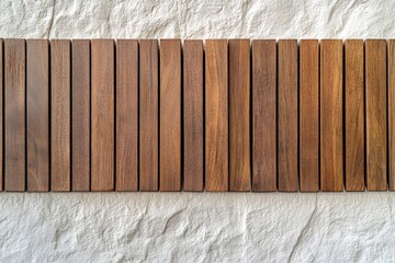 Poster - A row of vertical wooden panels is neatly aligned against a textured white concrete wall, creating a visually appealing contrast between natural and industrial elements.