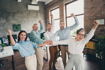 Wall Mural - Photo of teamwork startup partners hold hands support winning comfortable nice creative startup office loft room interior