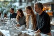 © AbdulRahmanUzair - A Group of Architects Examining a Detailed Model of a City