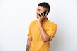© luismolinero - Young caucasian Brazilian man isolated on white background keeping a conversation with the mobile phone with someone