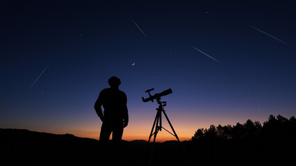 Wall Mural - amateur astronomer looking at the evening skies, observing planets, stars, moon and other celestial 