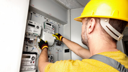 Wall Mural - Technician working on a modern electricity power meter station in a building.