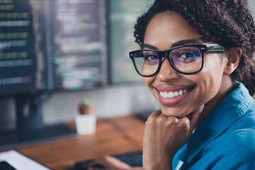 Photo of lovely young lady look camera dreamy cheerful dressed blue shirt comfortable programmer startup office loft room interior