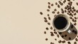 © sarun - A close-up of coffee beans scattered around a mug of black coffee, against a solid beige background.