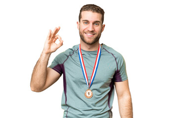 Wall Mural - Young handsome blonde man with medals over isolated chroma key background showing ok sign with fingers