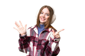 young pretty woman wearing winter muffs over isolated chroma key background counting seven with fing