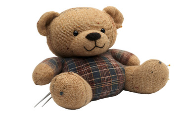 a stuffed teddy bear with a plaid shirt