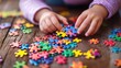 © irma - Child's Hands Putting Together a Colorful Jigsaw Puzzle