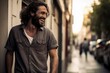 © MediaRaw - A man with a beard is smiling and laughing while standing on a sidewalk