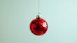 © NK - Red mirrored disco ball ornament on light green background, festive decoration concept