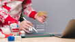 © Mdisk - A person in a festive sweater uses a tablet to make a secure online purchase, emphasizing the importance of online security during holiday shopping