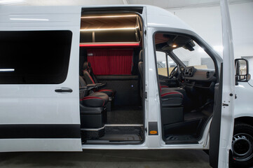 Comfortable interior of a passenger bus with soft seats. The design is made to order. Private covering of cars. Various elements of the bus interior.