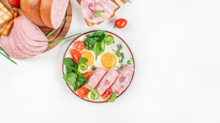 Wall Mural - Breakfast with fried eggs, ham and salad. Sliced boiled ham sausage, Keto breakfast. top view. copy space