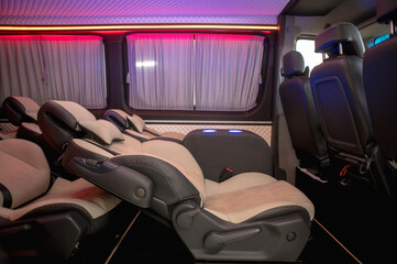 Comfortable interior of a passenger bus with soft seats. The design is made to order. Private covering of cars. Various elements of the bus interior.