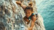 © Galib - A woman rock climbs a steep rock face.