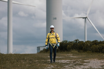 Fototapete - Man engineers holding rope to maintenance working in wind turbine. Renewable energy power wind turbine. Technology protect environment reduce global warming problems.