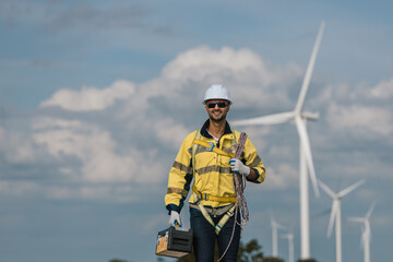 Man engineers holding tools box and rope to maintenance working in wind turbine. Renewable energy power wind turbine. Technology protect environment reduce global warming problems.