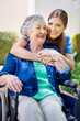 © C.Arcurs/peopleimages.com - Elderly, woman and wheelchair with hug in garden at retirement home for comfort, rehabilitation or healthcare service. Nurse, caregiver and patient with disability, consulting or wellness support