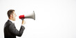 © Who is Danny - Businessman in suit shouting into a megaphone on a clean white background. The image represents communication and announcement concepts