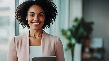 Wall Mural - Smiling Black Woman in a Pink Blazer Holding a Tablet